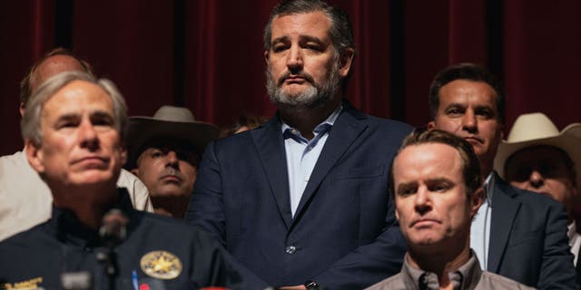 Sen. Ted Cruz, R-Texas, looks on as Texas Gov. Greg Abbott speaks during a press conference at Uvalde High School on May 25, 2022 in Uvalde, Texas.  
