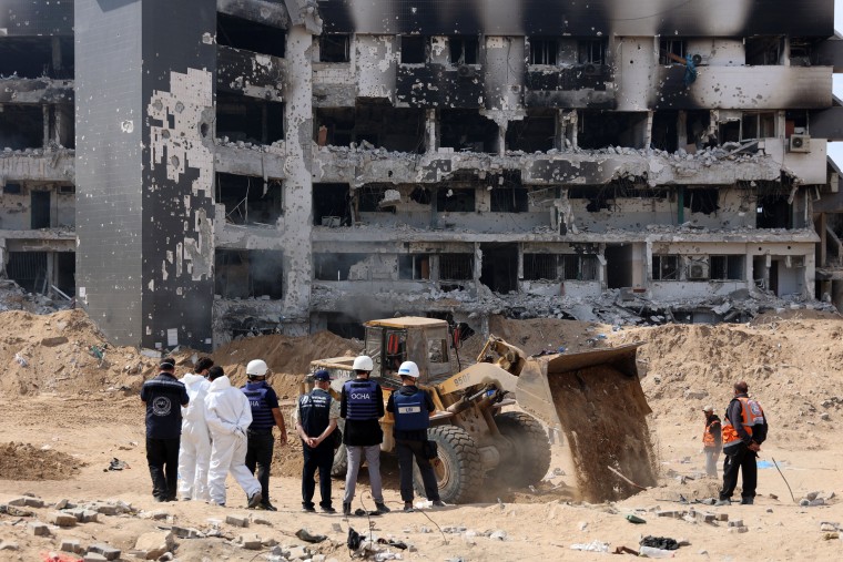 A United Nations (UN) team visit as Palestinian civil defence recover human remains the grounds of Al-Shifa hospital in Gaza