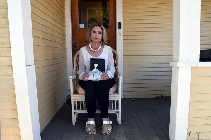 Abby Swoveland sits with what the Return to Nature Funeral Home said were her mother's ashes.